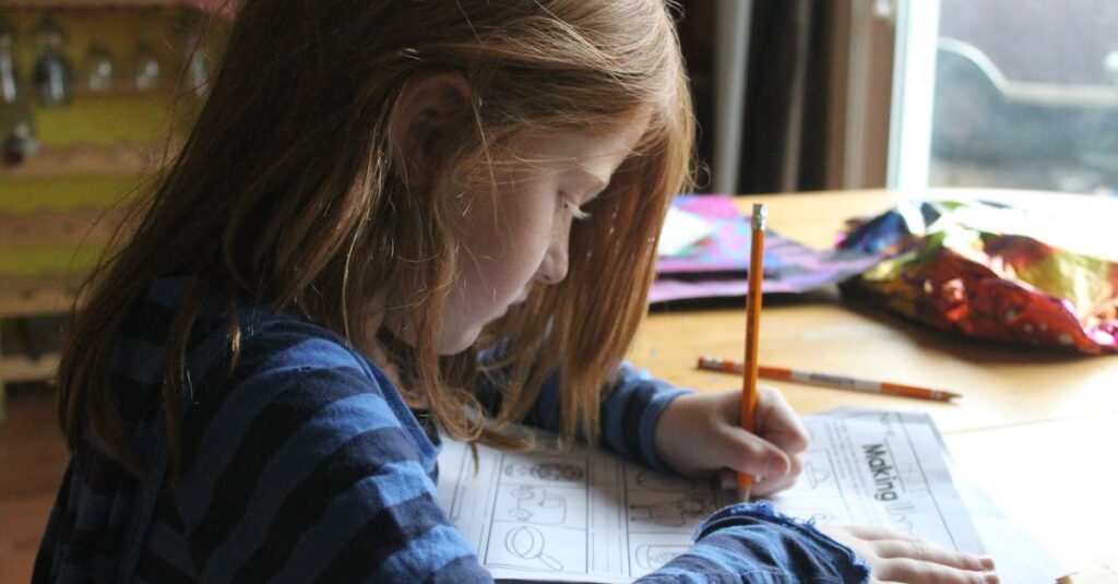 Young girl focused on homework at kitchen table with natural light.
